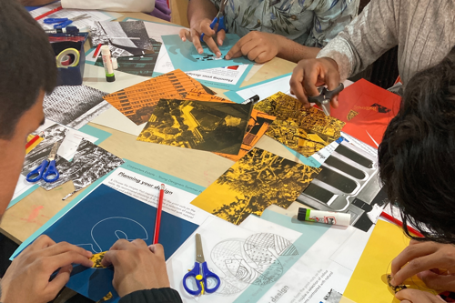 Young people gathered around a table, making paper clipping collages