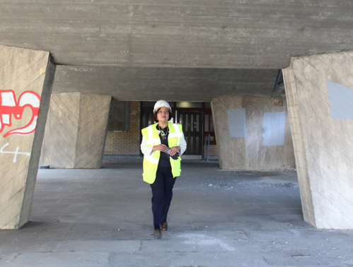 Mayor Rokhsana Fiaz OBE, wearing a high vis and a hard hat, walks in front of the entrance to James Riley Point